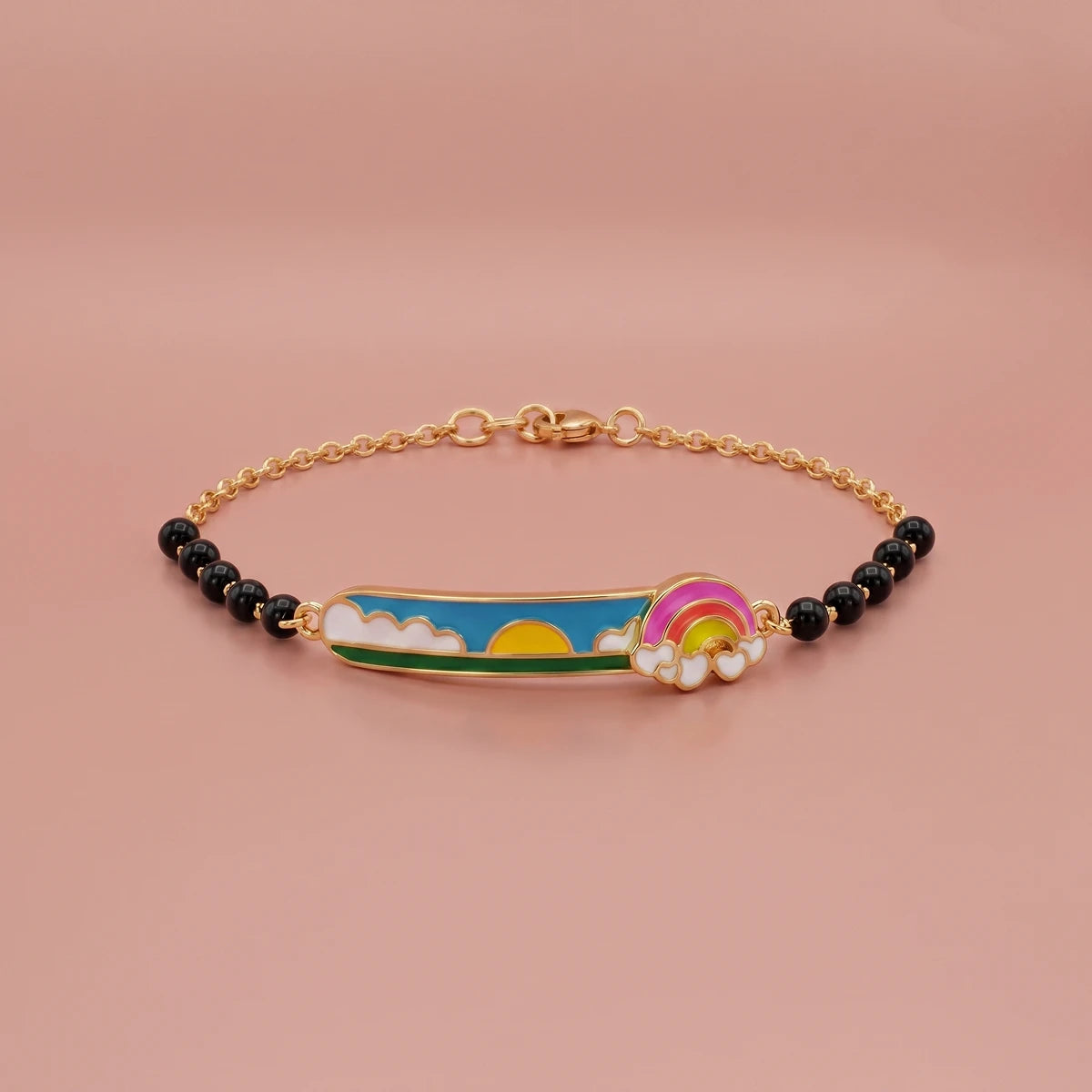 Gold kids bracelet featuring bright rainbow and cloud accents